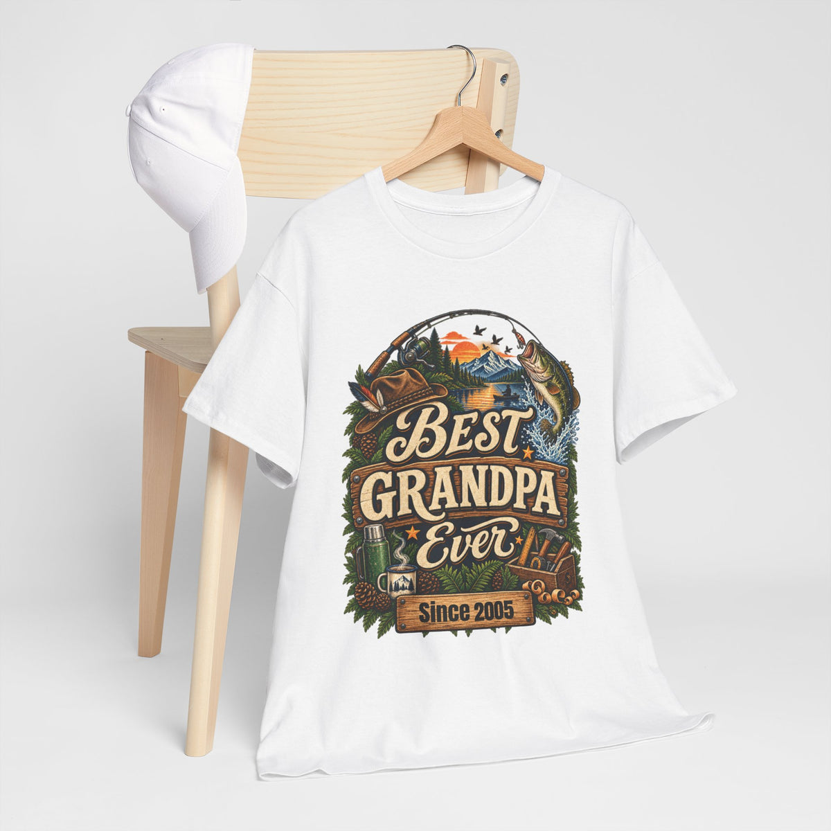 White Best Grandpa Ever t-shirt hanging on a wooden hanger by a chair